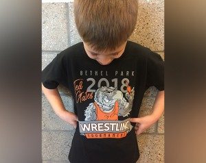 A youth wrestler sports his 2018 Ted Gates tournament shirt.